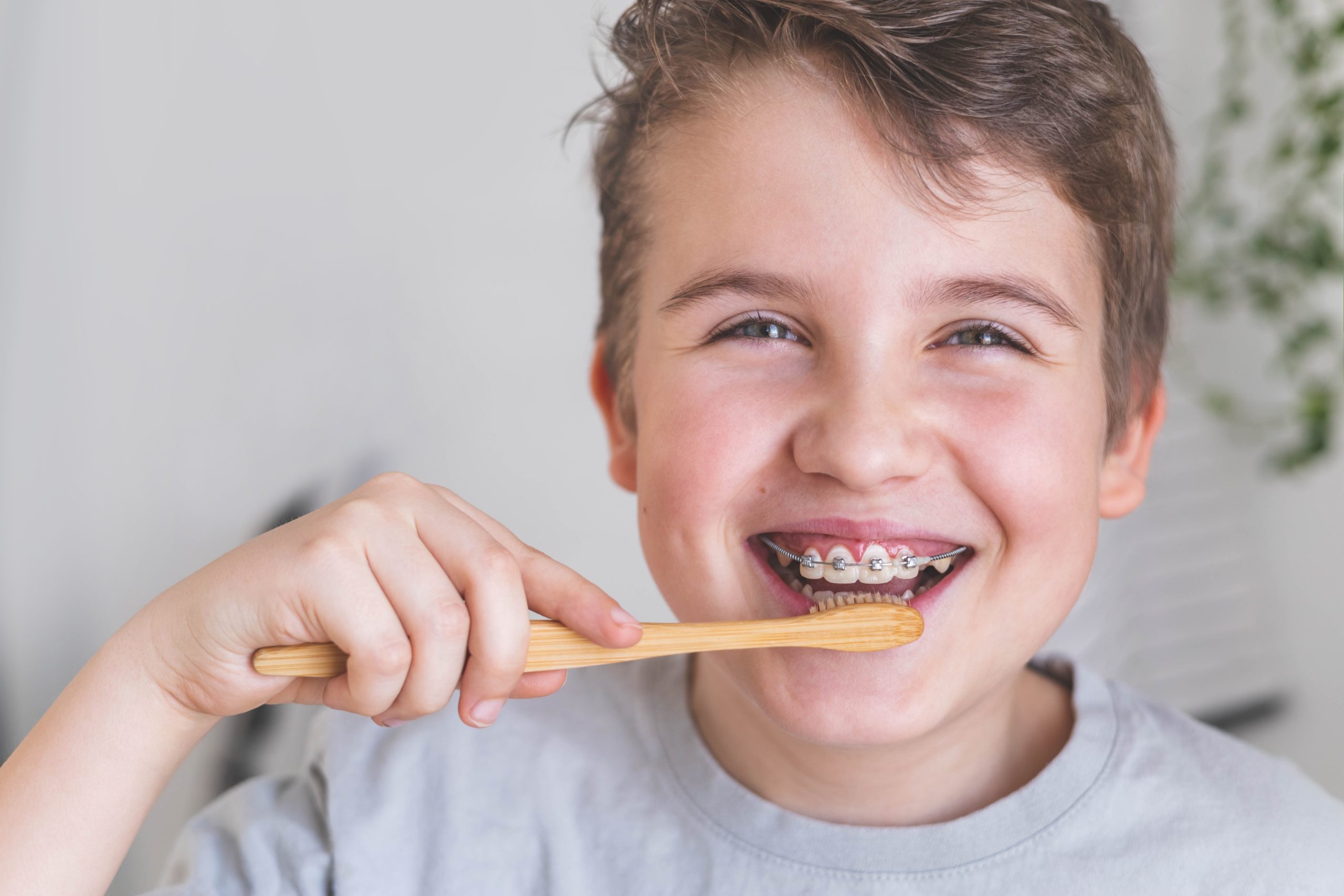 Happy,Boy,Child,Cleaning,Teeth,With,Braces,Use,Wooden,Eco
